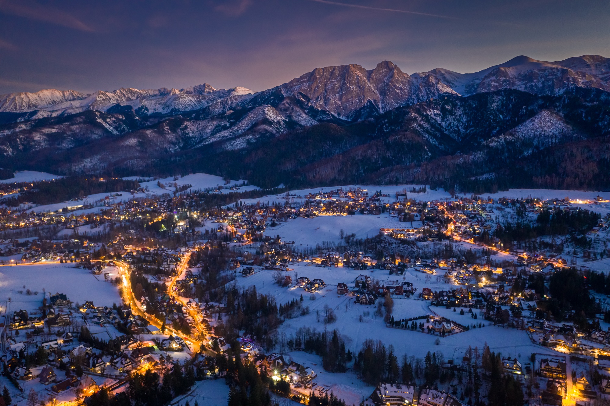 Stunning illuminated Zakopane city in winter at night, aerial view